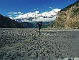 303 Jerome Ryan Trekking On Kali Gandaki Riverbed After Tukuche After passing through Tukuche, Jerome Ryan walked along the broad Kali Gandaki riverbed until I noticed the other trekkers were using the trail on the cliff side. Luckily I crossed a few streams and scrambled back to the trail without getting my boots wet.